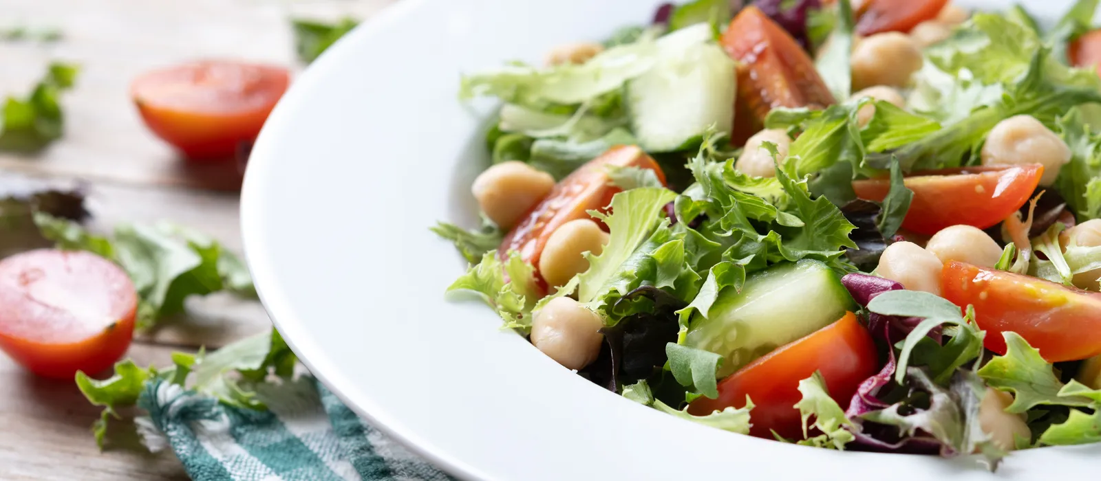 1766585056-healthy-chickpea-salad-with-tomatolettuce-cucumber-wooden-table