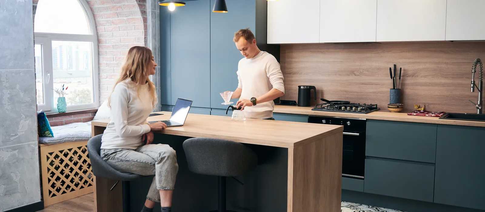 1768481978-woman-man-working-laptop-home-modern-kitchen