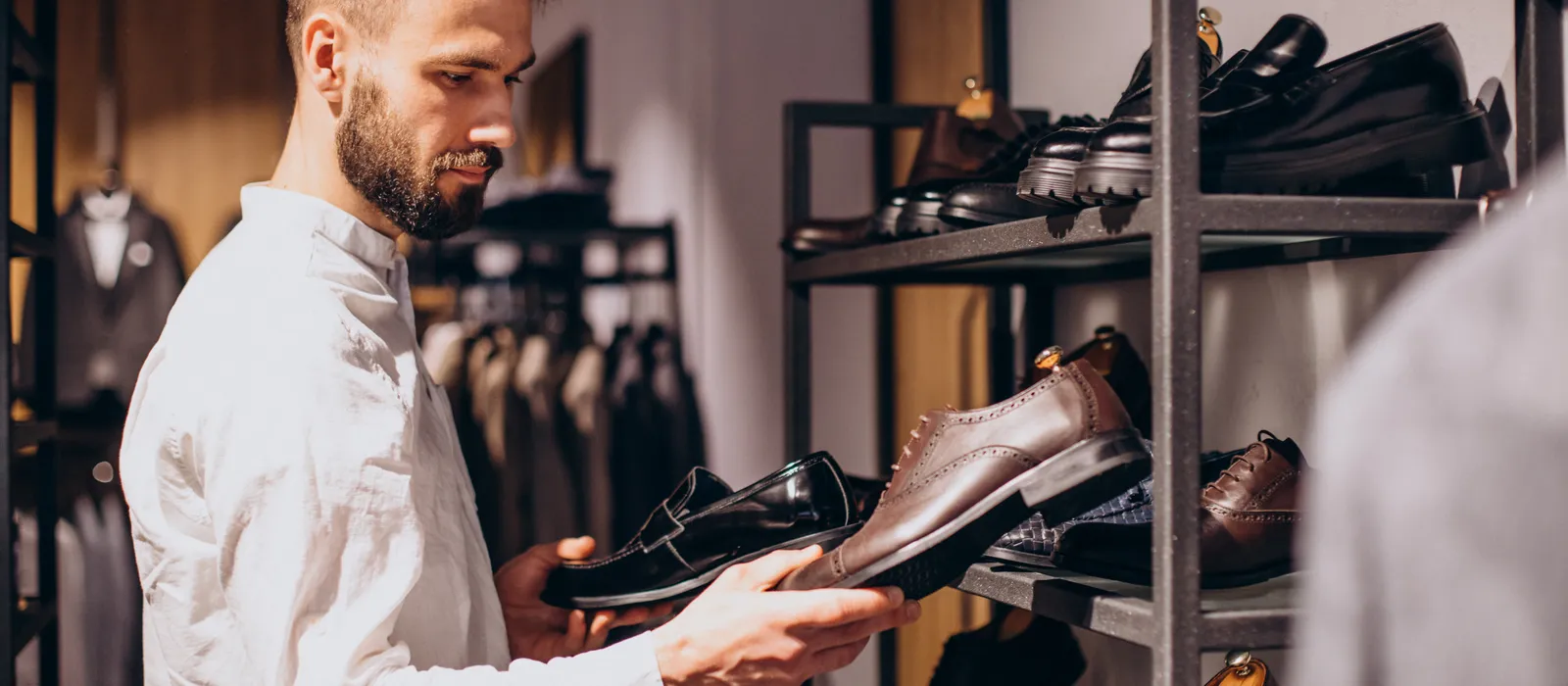 1769097971-man-choosing-foot-wear-mens-store