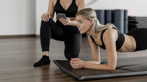 1761901204-young-woman-exercising-gym-doing-plank