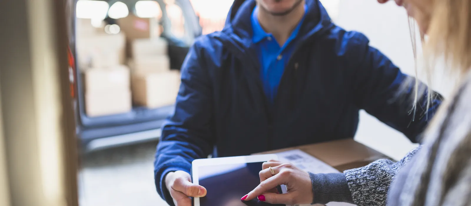 1763635862-woman-giving-online-signature-deliveryman