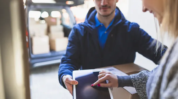 1763635862-woman-giving-online-signature-deliveryman