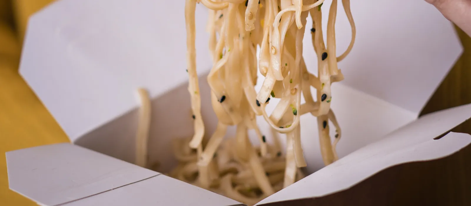 1769090707-woman-holding-noodles-chopsticks