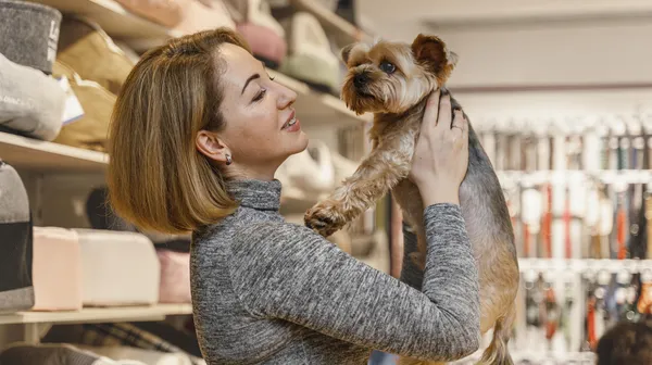 1778852688-woman-holding-cute-little-dog-pet-shop