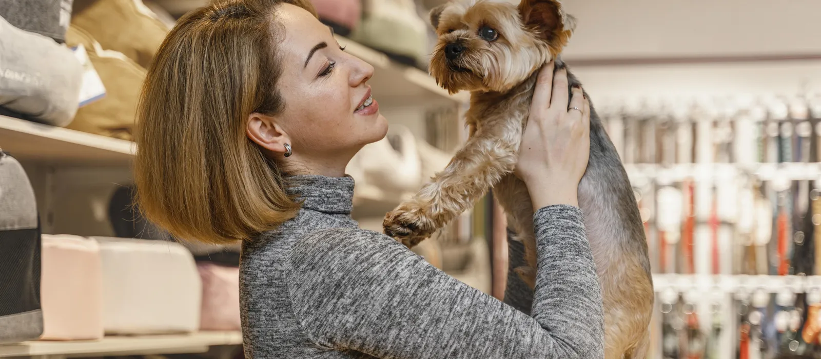 1778853547-woman-holding-cute-little-dog-pet-shop