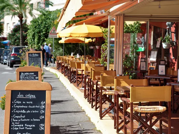 French restaurant scene with menu board